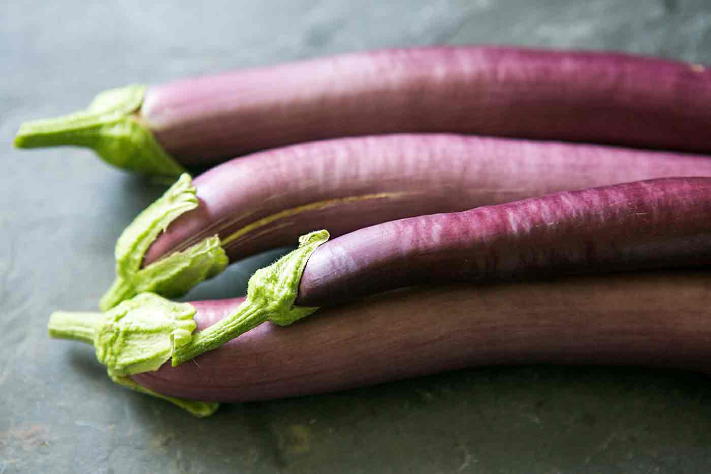 Long Purple Eggplant Growing on the Plant